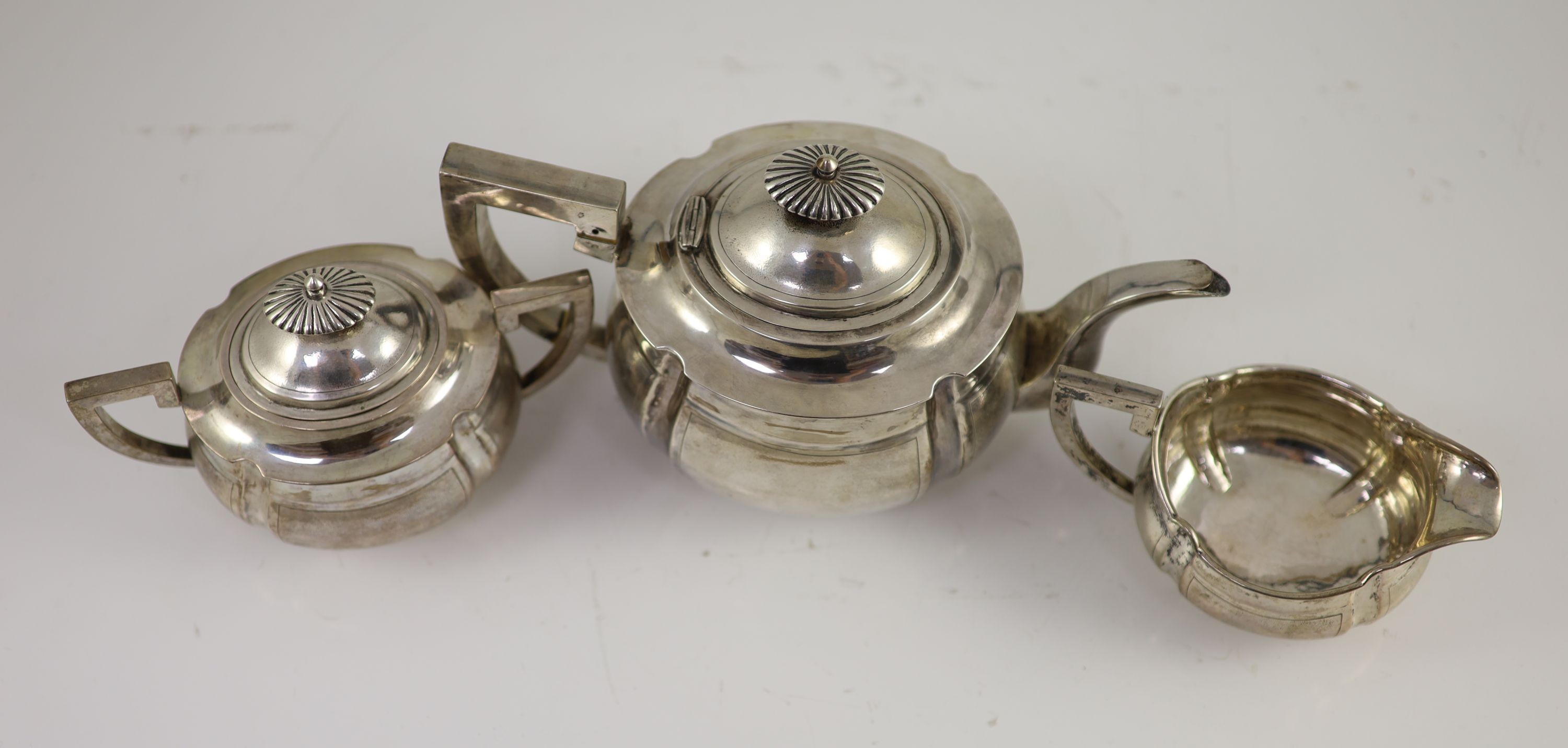 An early 20th century Chinese white metal three piece tea set by Zee Wo